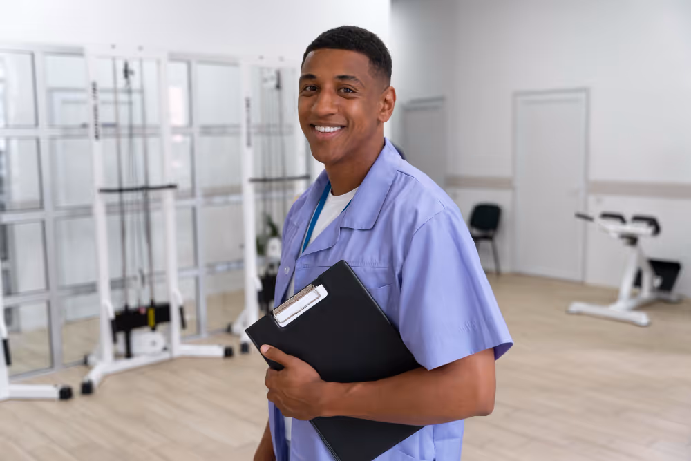 Young male healthcare technician smiling in a medical facility