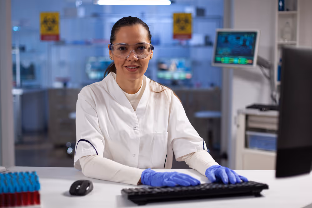 Female laboratory technician working at a computer