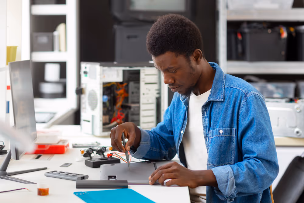 Young male technician working with electronics and circuit boards