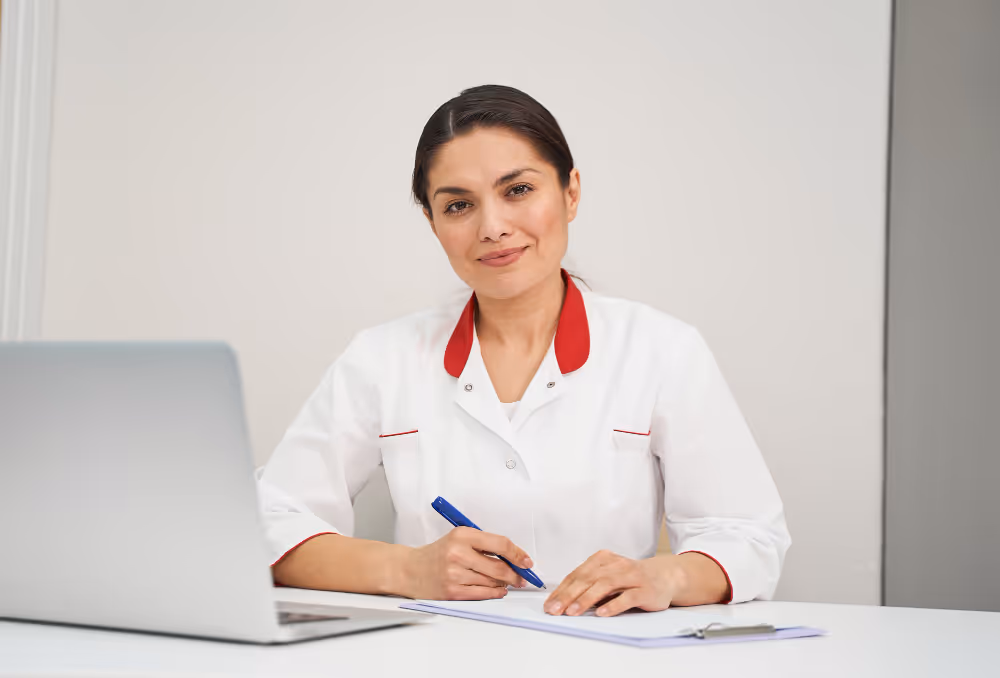 Female technician in uniform smiling with a clipboard