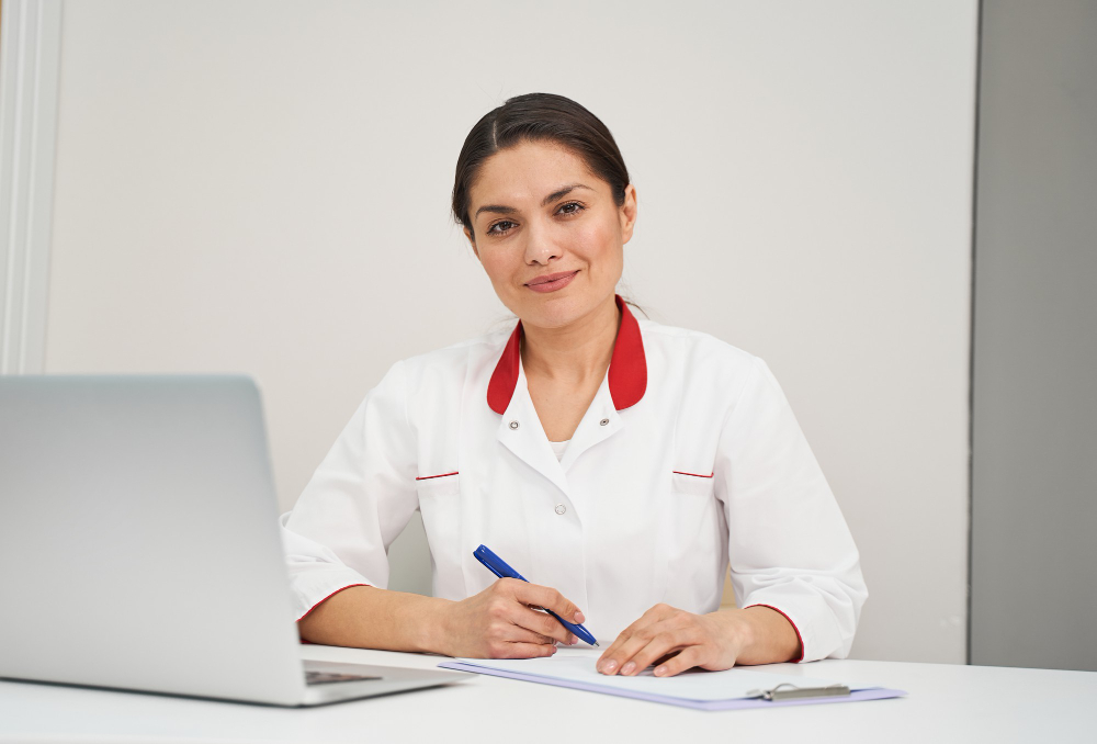 Female technician in uniform smiling with a clipboard