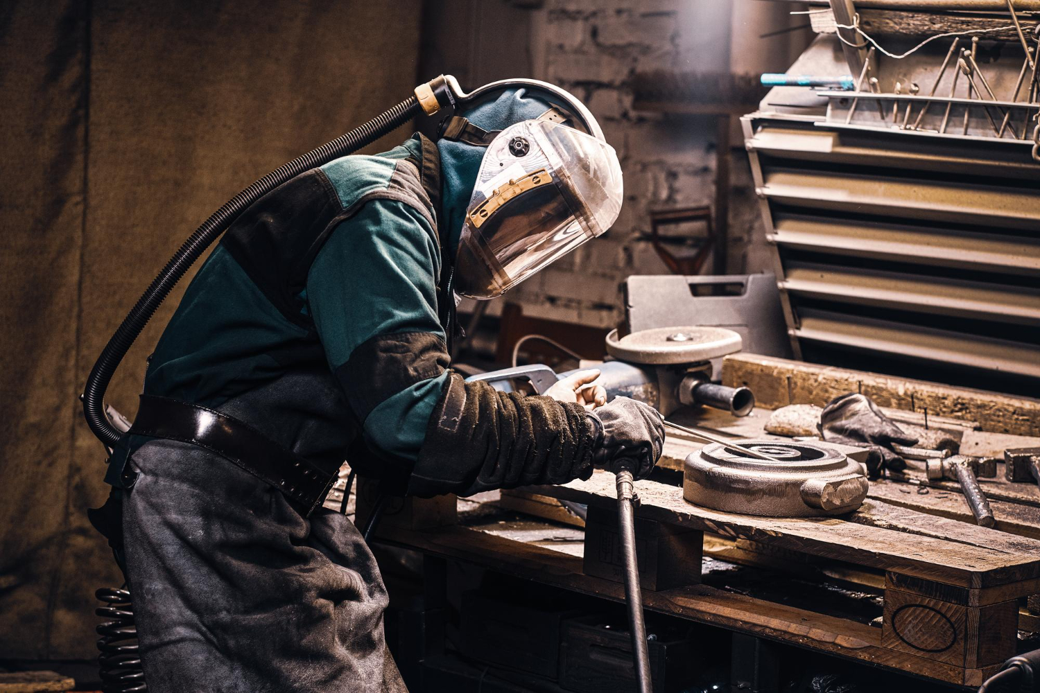 Welder performing metal fabrication with protective equipment 