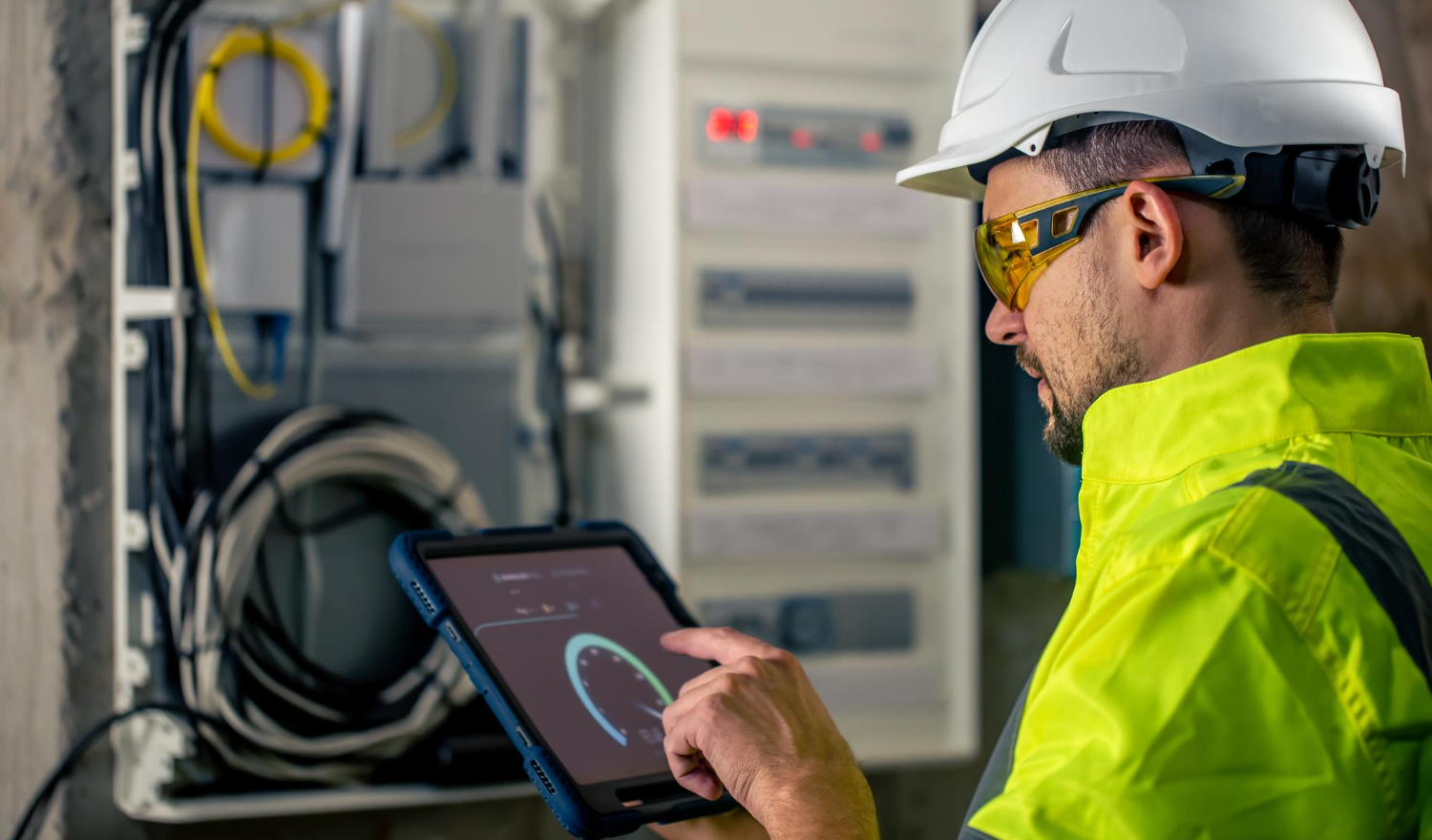 Instrumentation technician calibrating sensors in a control room