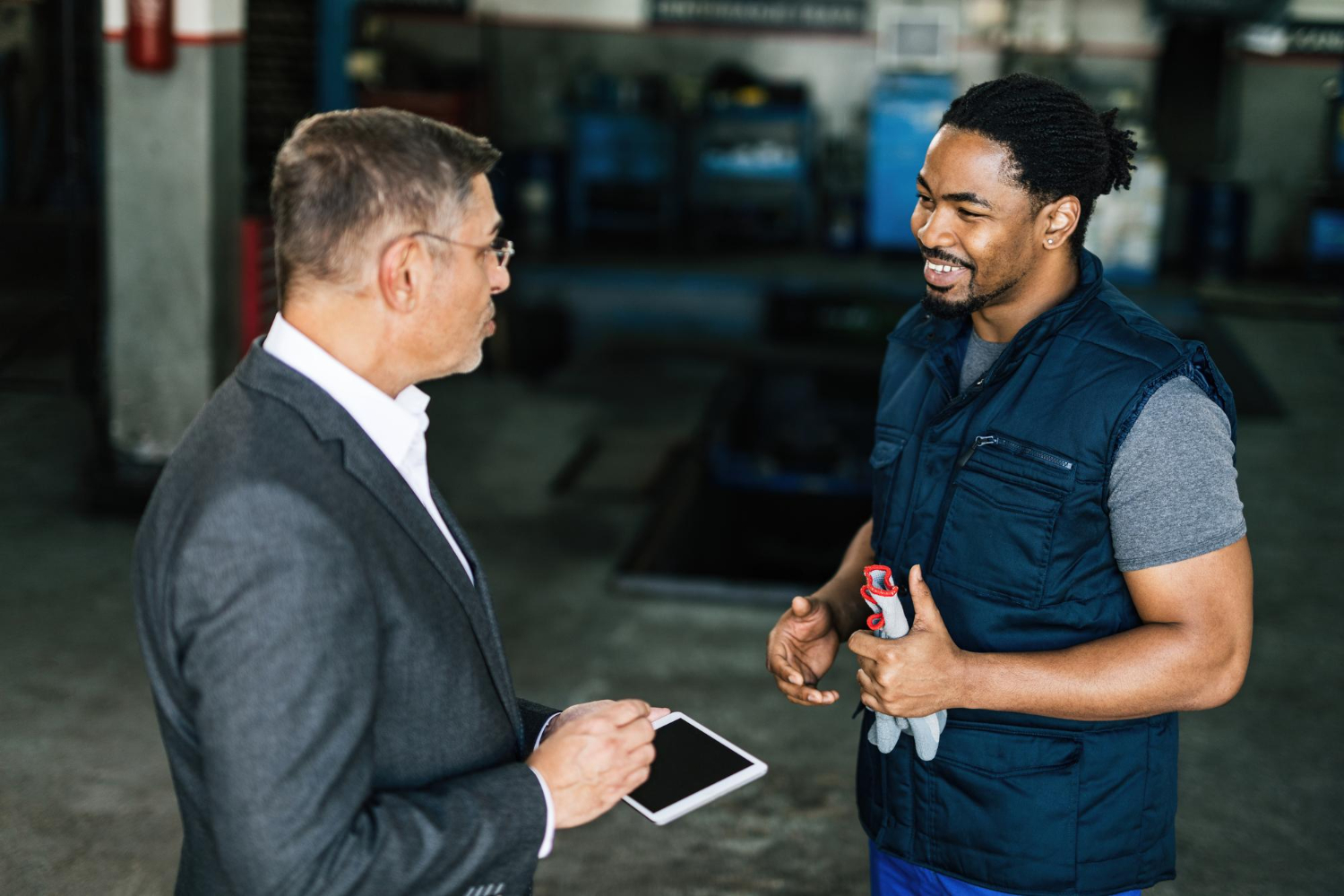 Mid-career adult receiving hands-on guidance from an experienced technician instructor