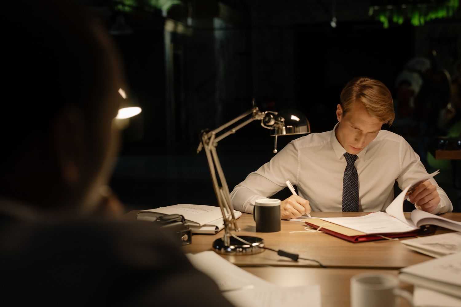 A technician in safety glasses reviewing a company handbook during an interview