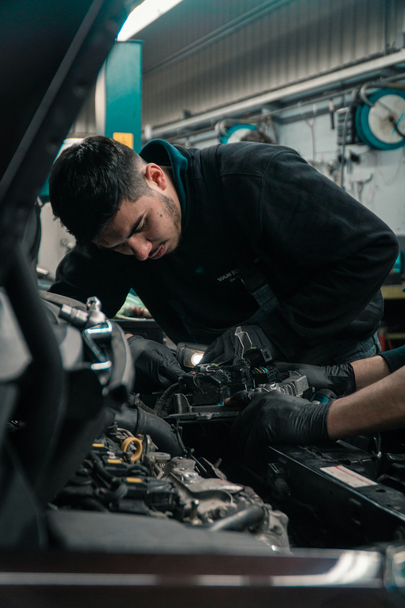 Automotive technician working on an engine, a role that often requires ASE certification
