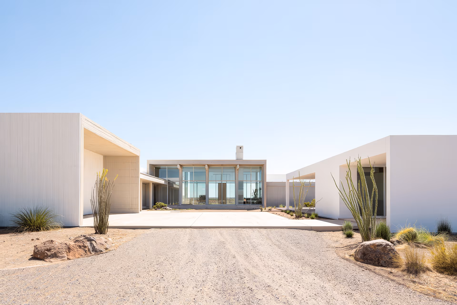 Person sitting on tennis court wearing striped socks and white sneakers surrounded by tennis balls and a wooden tennis racket.