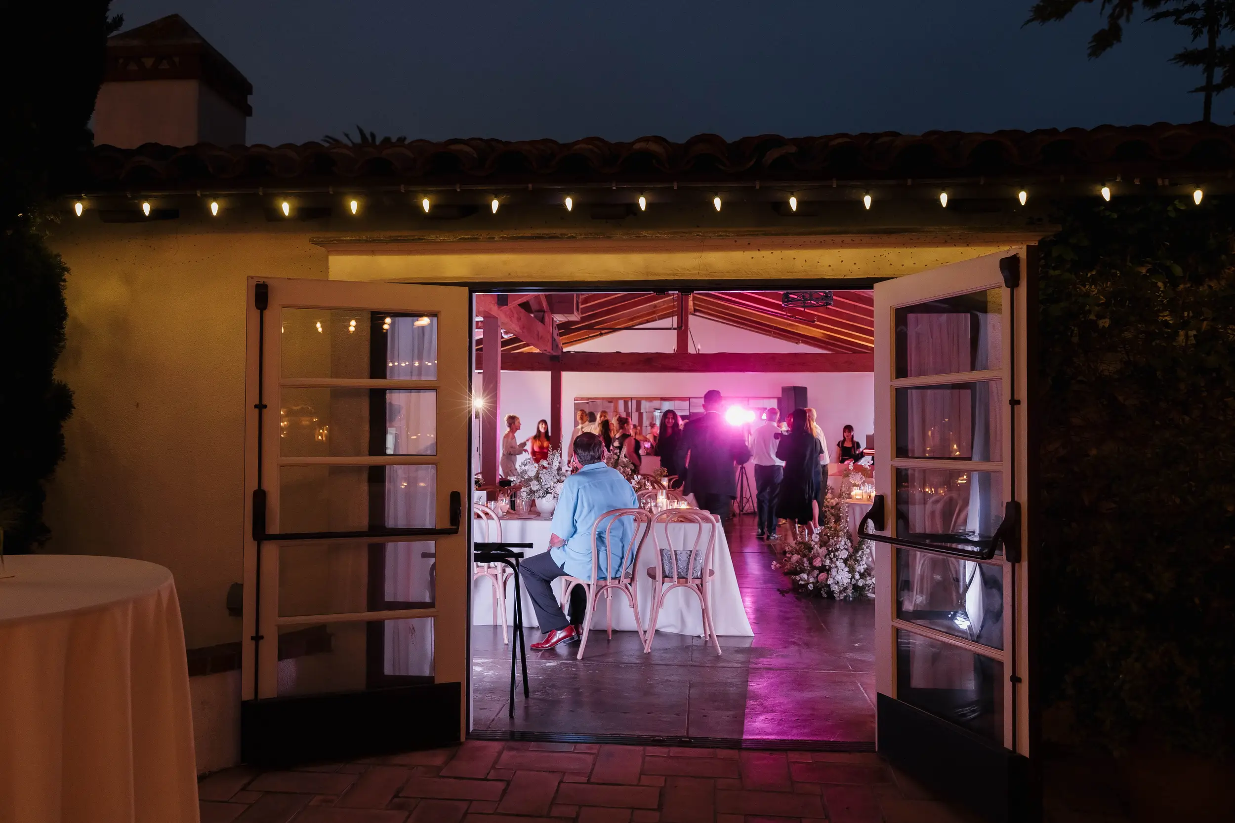 Looking into guests dancing inside The Casino San Clemente after the dinner reception has ended.