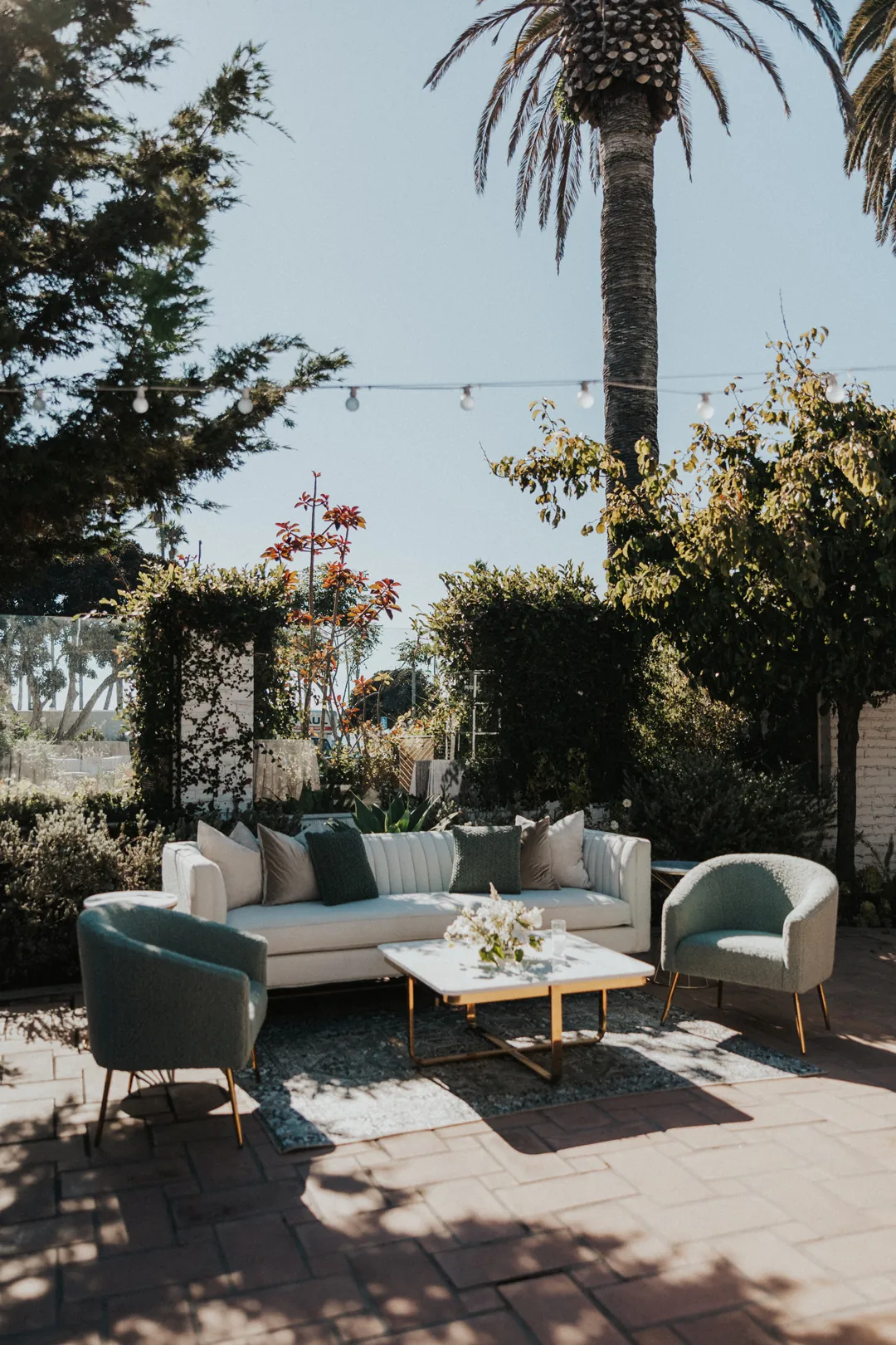 A modern, white and sea foam lounge awaits guests for cocktail hour on the Patio of the Stars.