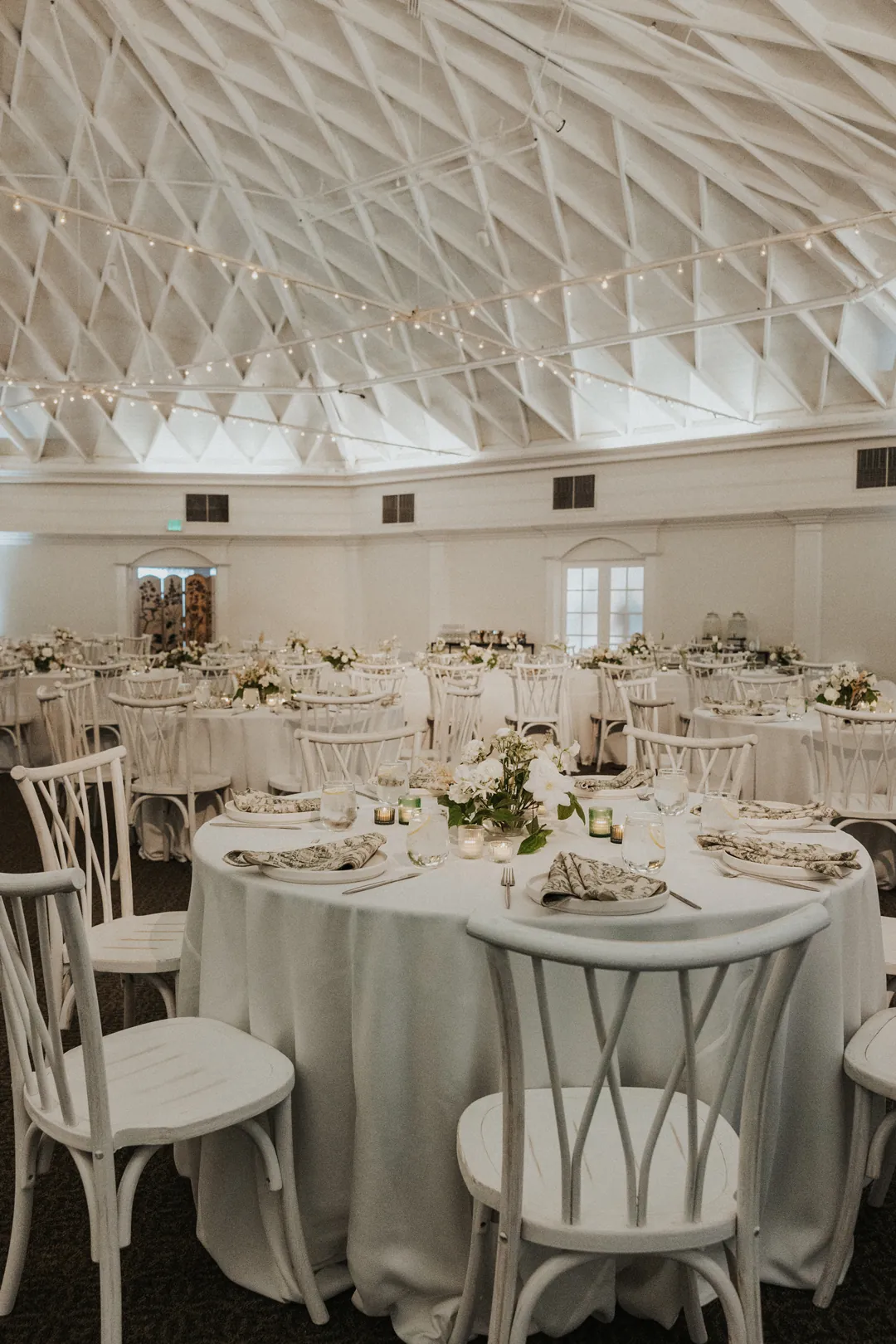 Coastal mixed with garden-style wedding reception decor fills the Casino's ballroom for this wedding.