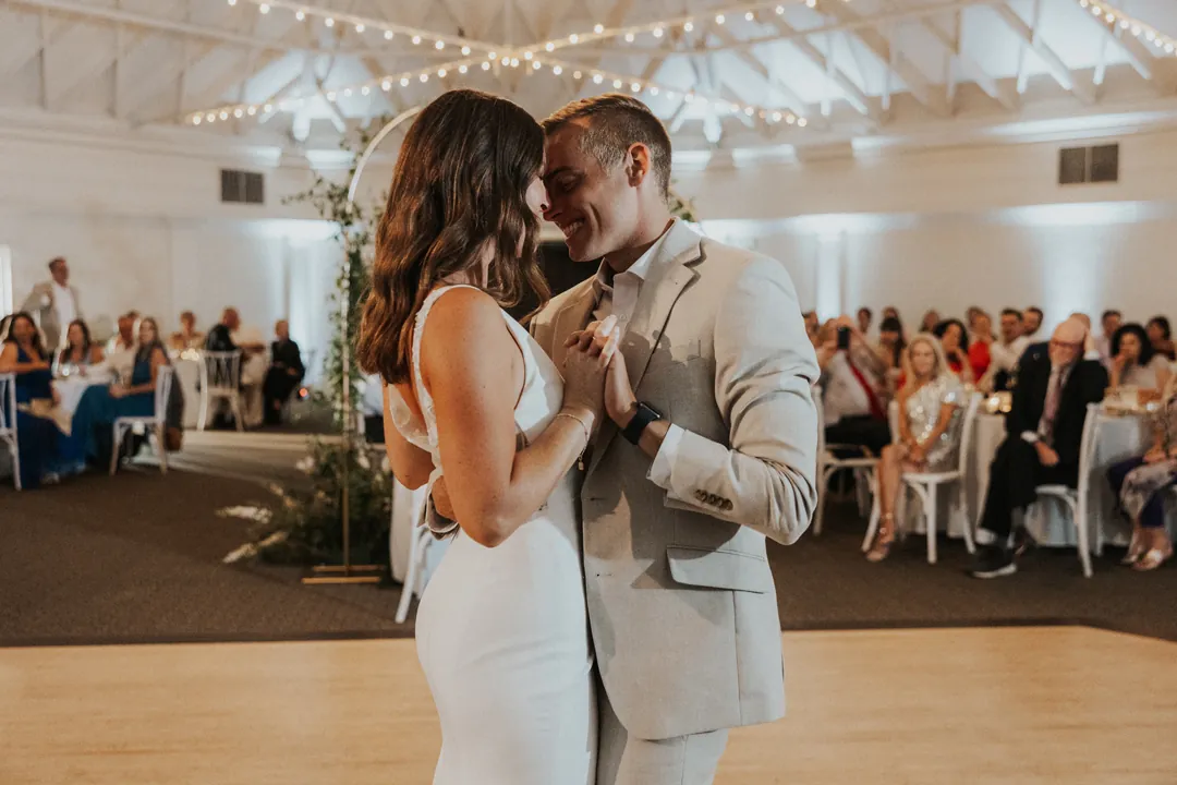 Bride and groom share their first look out on the dance floor.