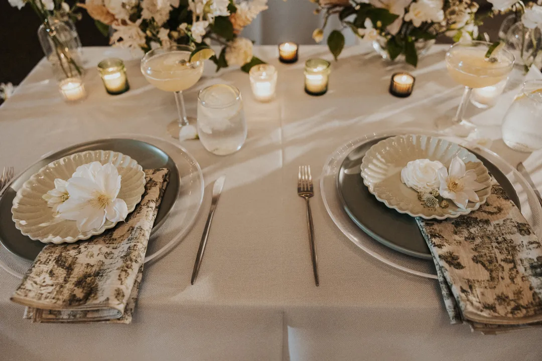 Patterned napkins and stoneware plates top tables at The Casino for this coastal wedding reception.