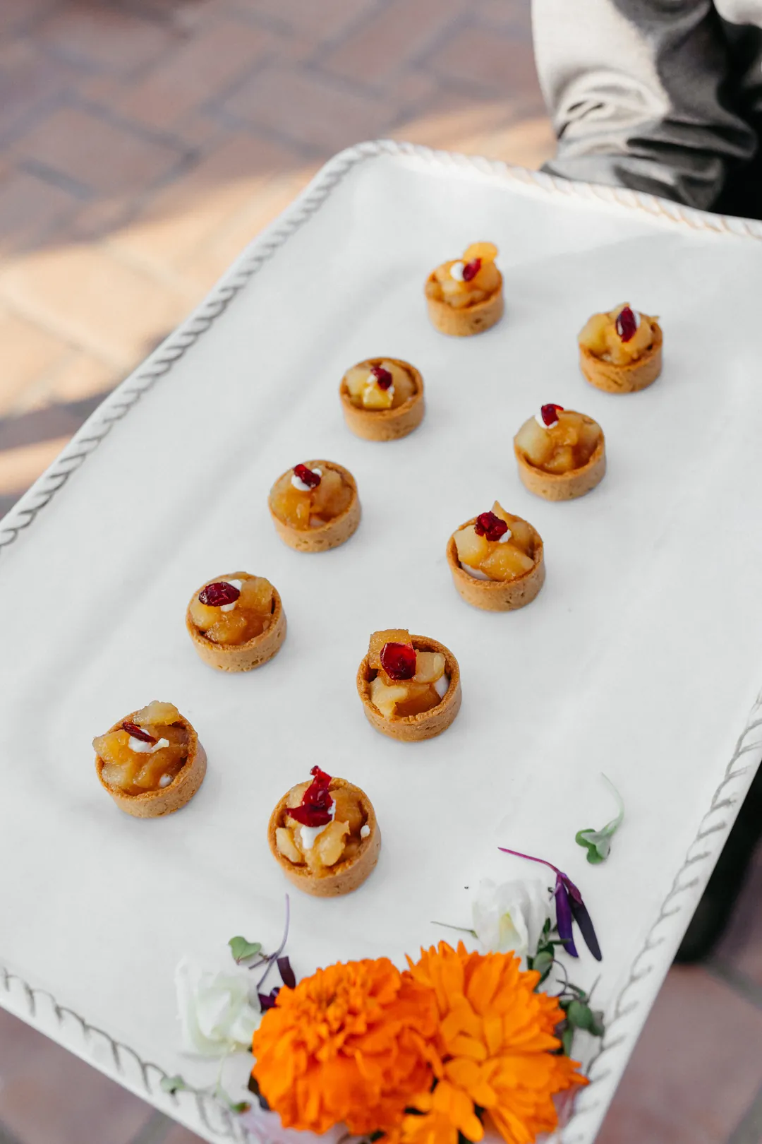Cocktail hour tray passed pear tarts.