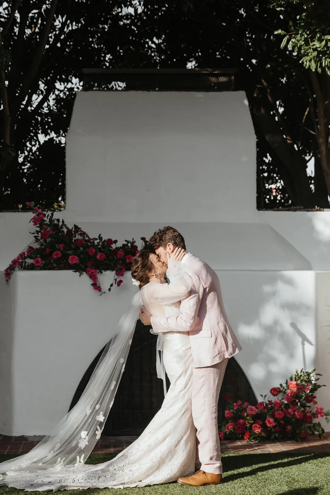 Bride and groom seal their ceremony with a kiss.
