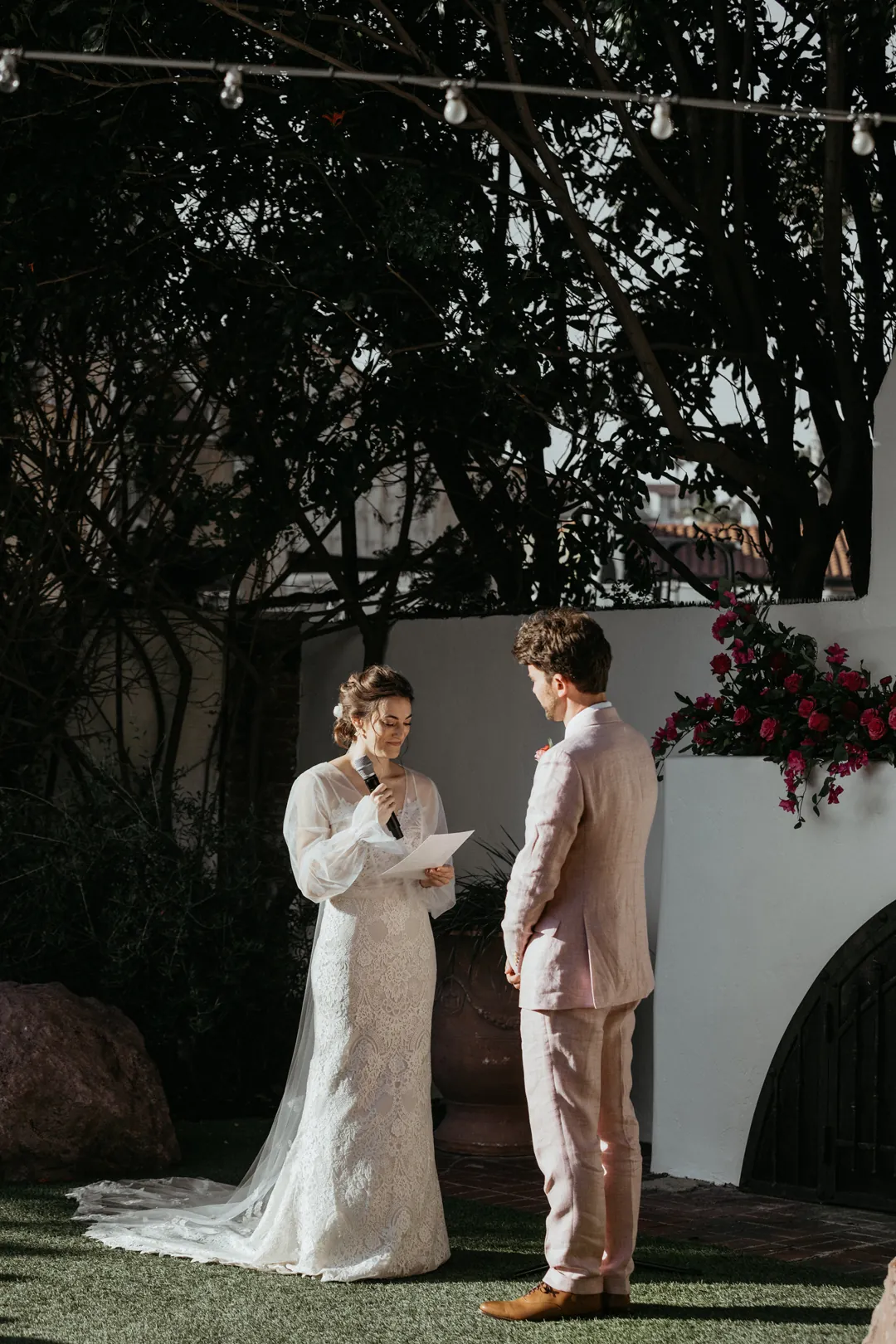 Bride reads vows to groom.