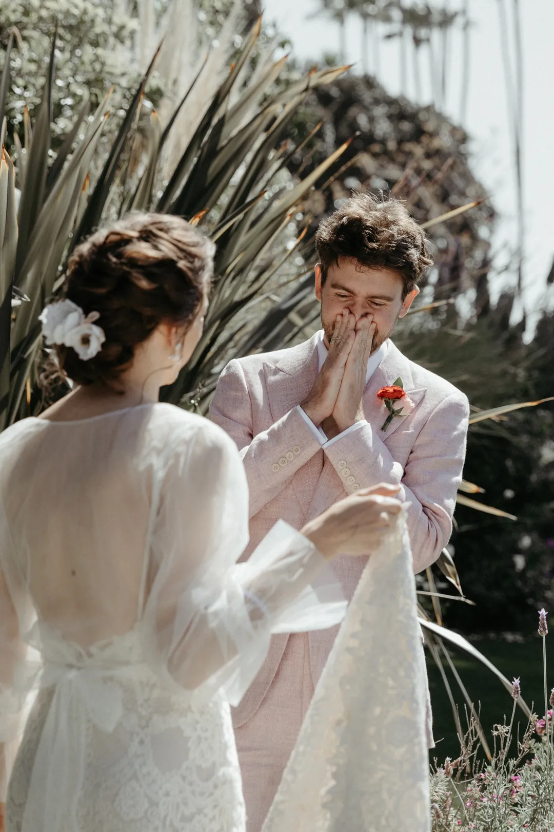 Groom smiles as he sees his bride for the first time during their first look.