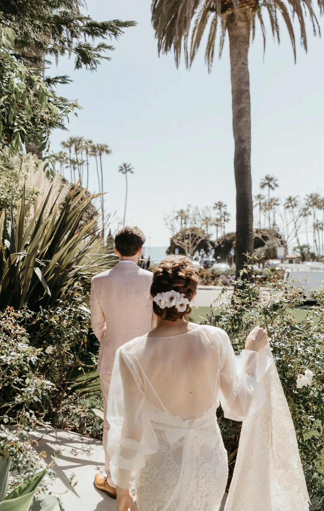 Bride approaches groom for their first look on the lawn of The Casino San Clemente.