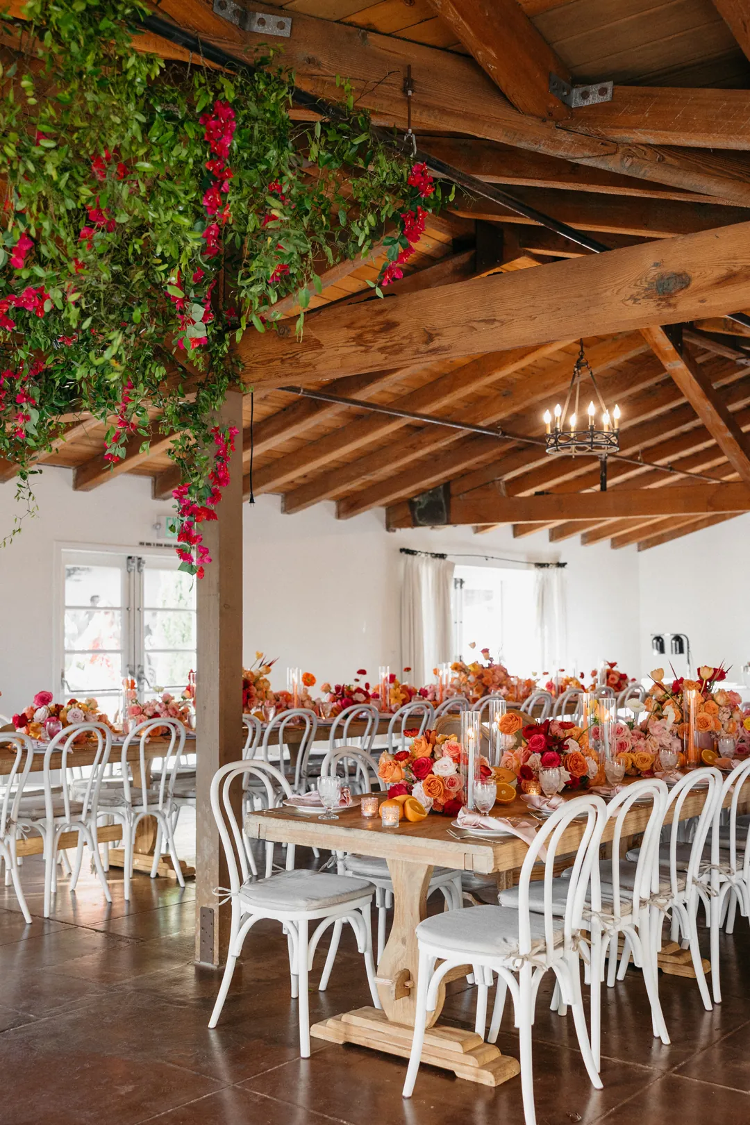 Colorful flowers and fresh fruit centerpieces top reception tables inside The Casino.