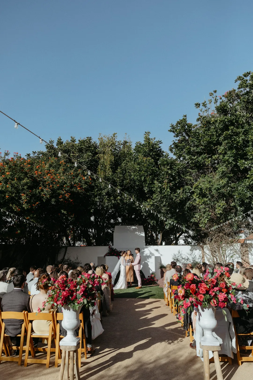 Bride and groom share their vows in front of family and friends in the Casino's Rock Garden.