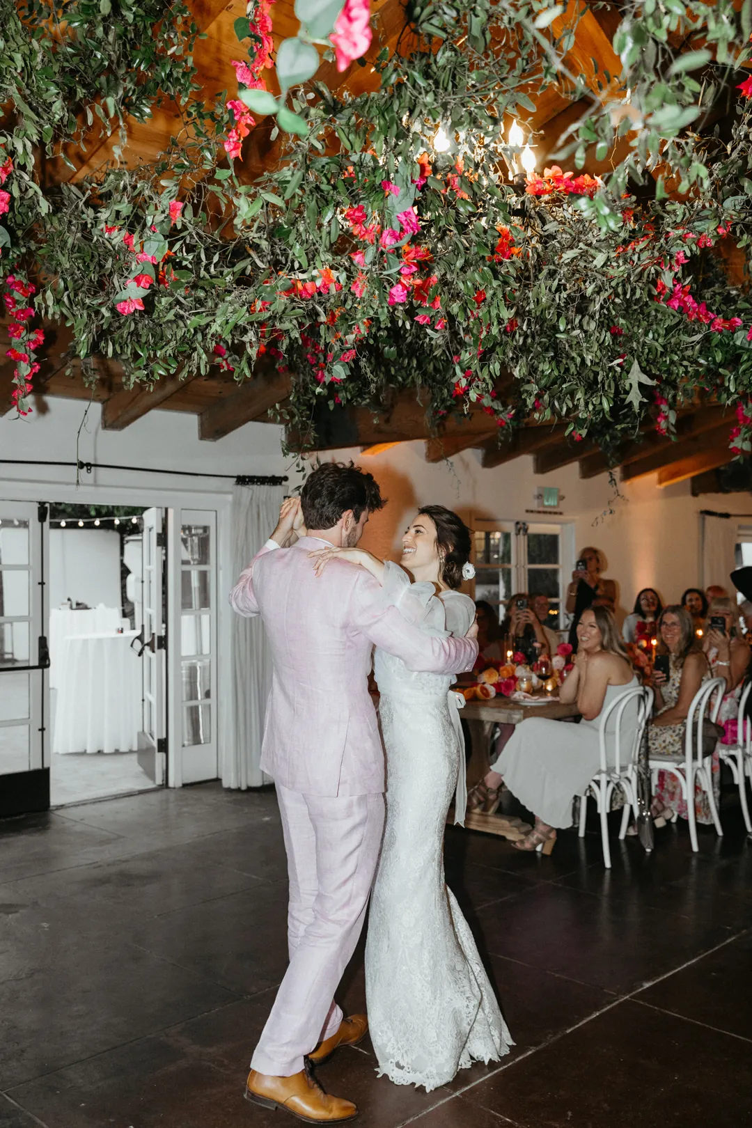 Bride and groom share first dance under bougainvillea inside The Casino.