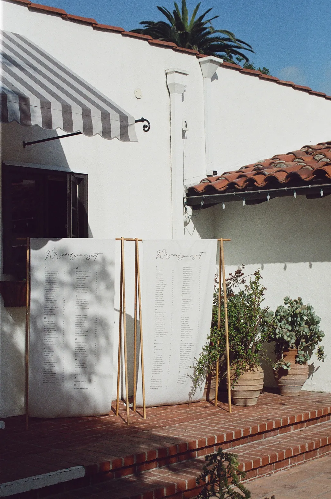 Linen draped seating chart sits on terrace.