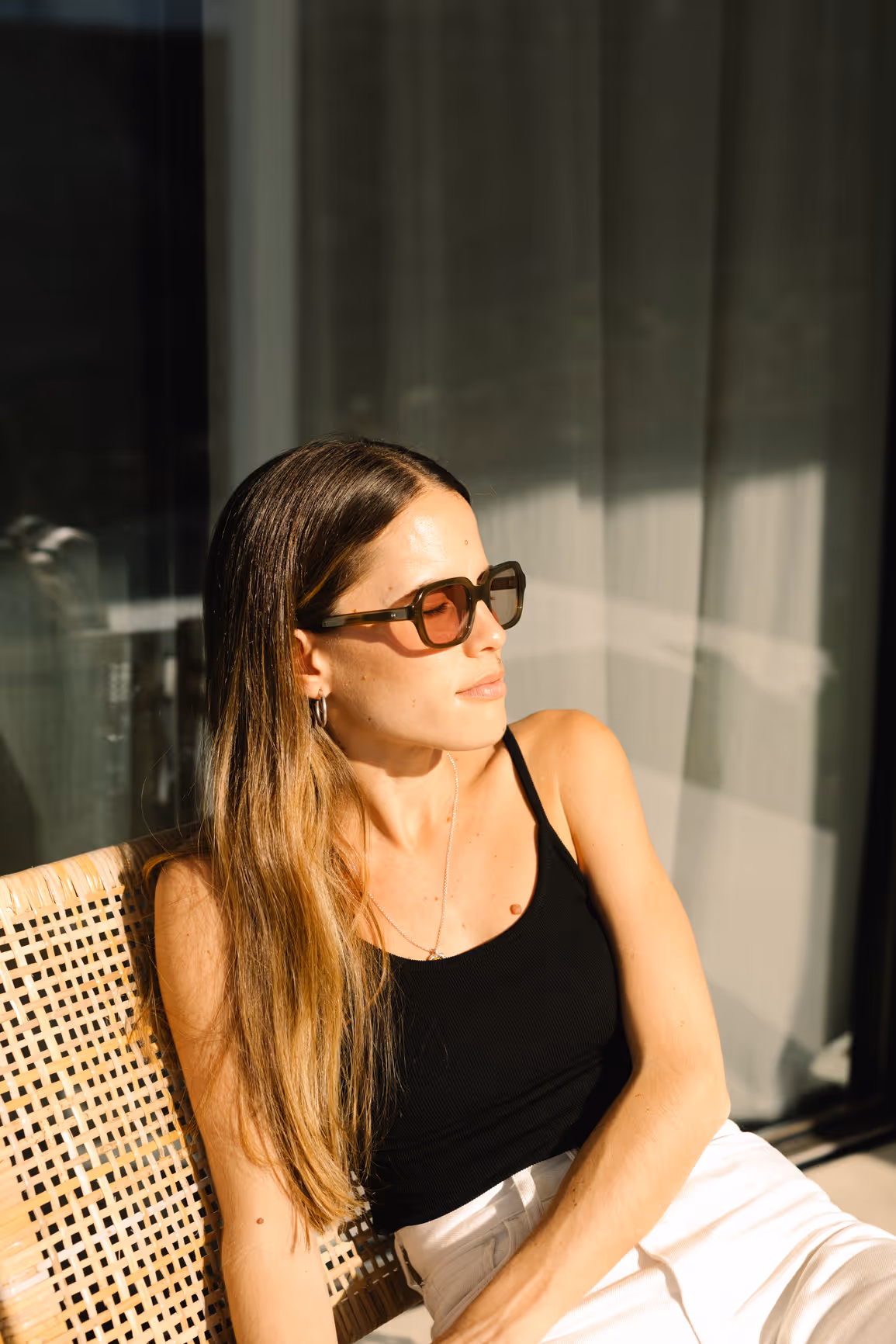A woman with sunglasses soaks up the sun.