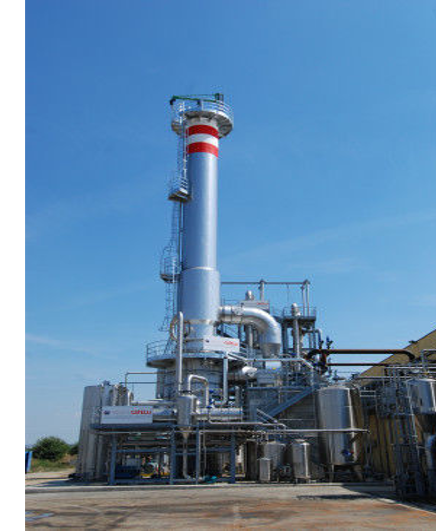 Wind turbine blades against a landscape.
