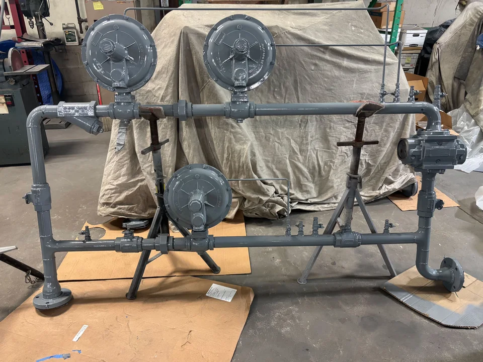 Commercial natural gas regulator run with three Fisher regulators on parallel headers, fabricated at JNL Fab.