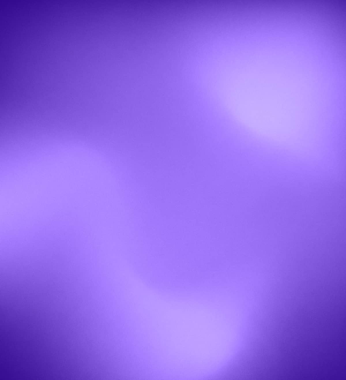 Abstract purple background with soft, glowing bokeh light effects.
