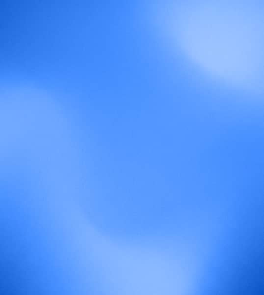 Soft blue gradient background with subtle light and dark blurred areas.