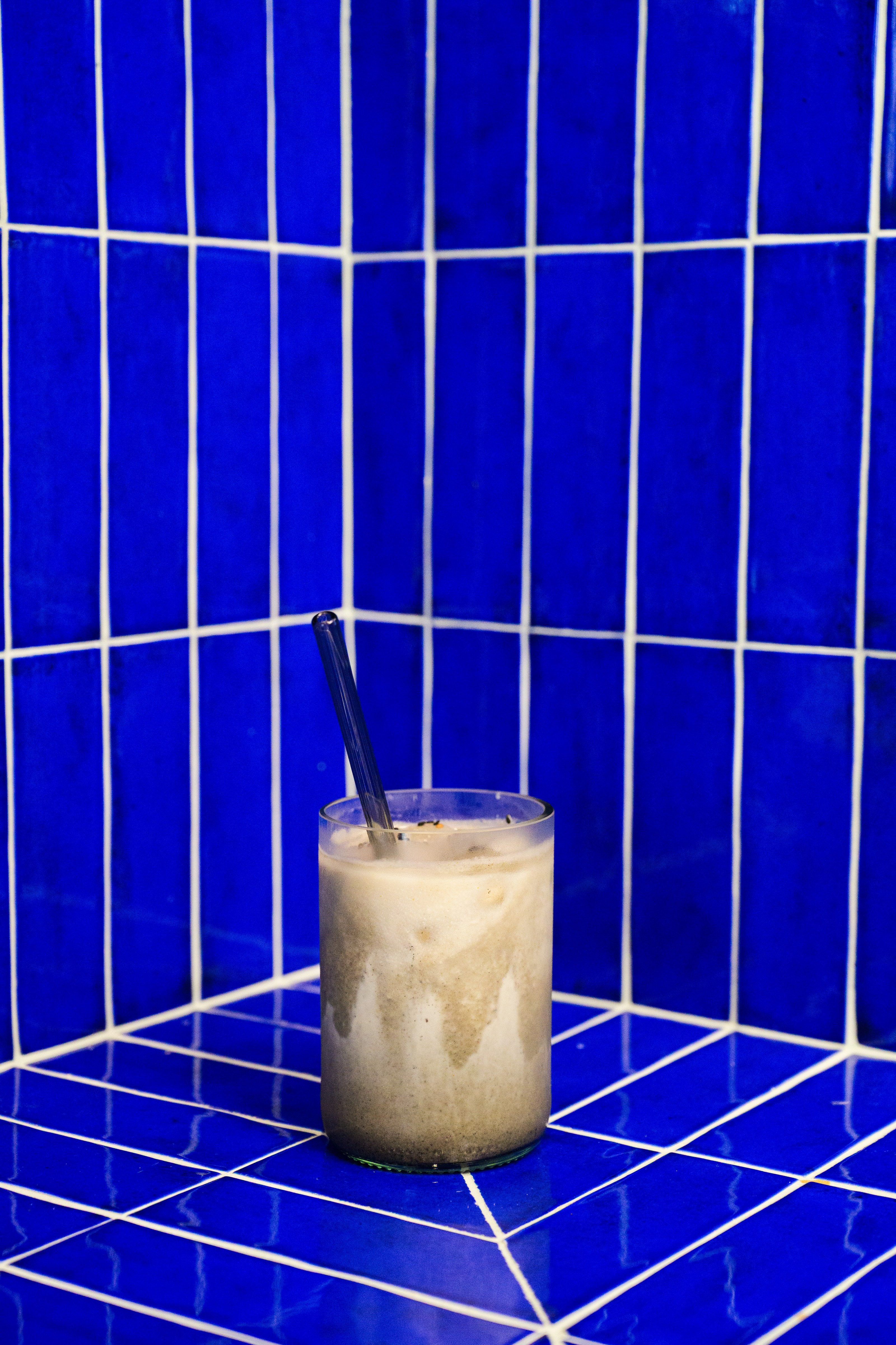 A minimalist restaurant drink image with a bold blue background