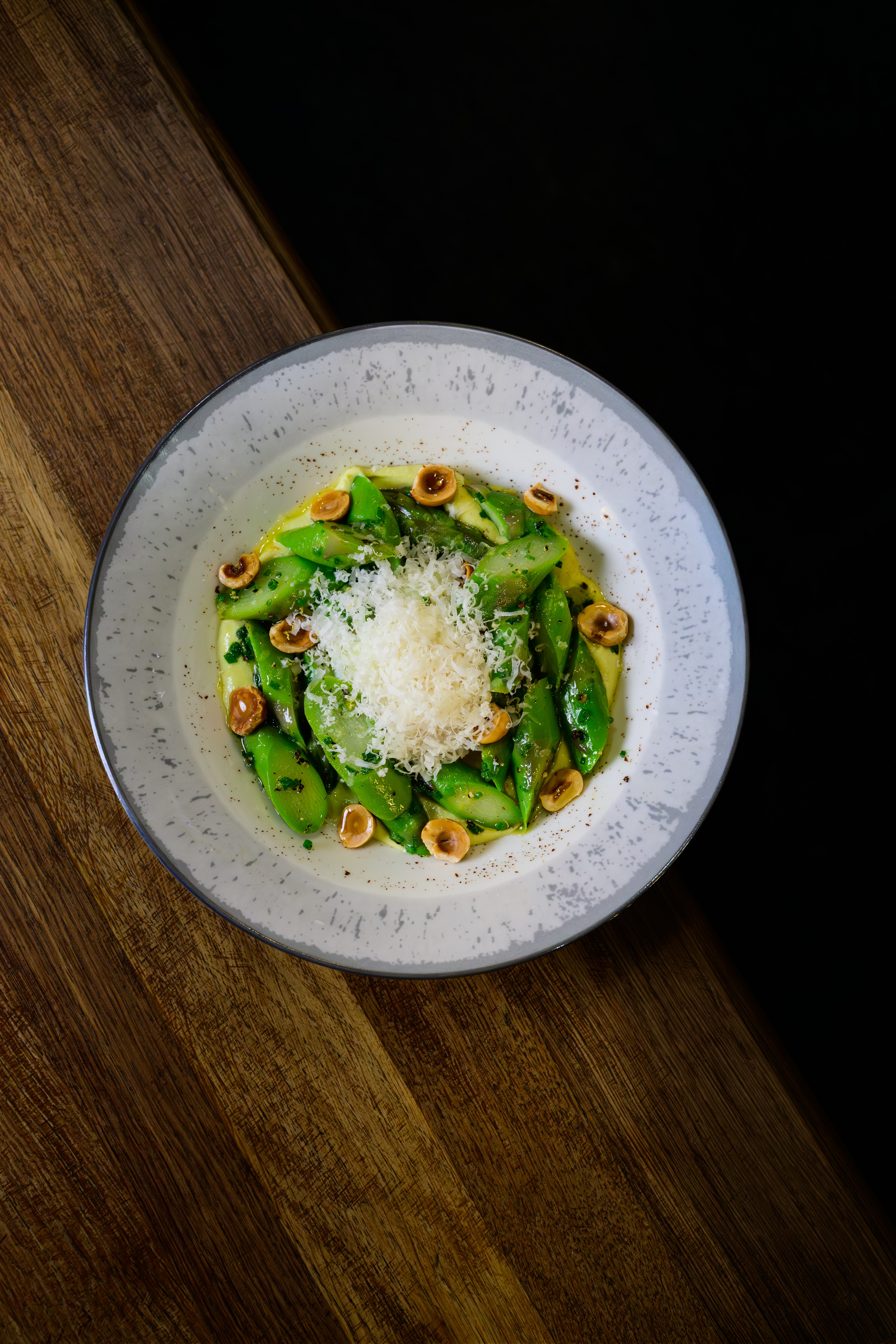 A plated green vegetable dish photographed for restaurant content