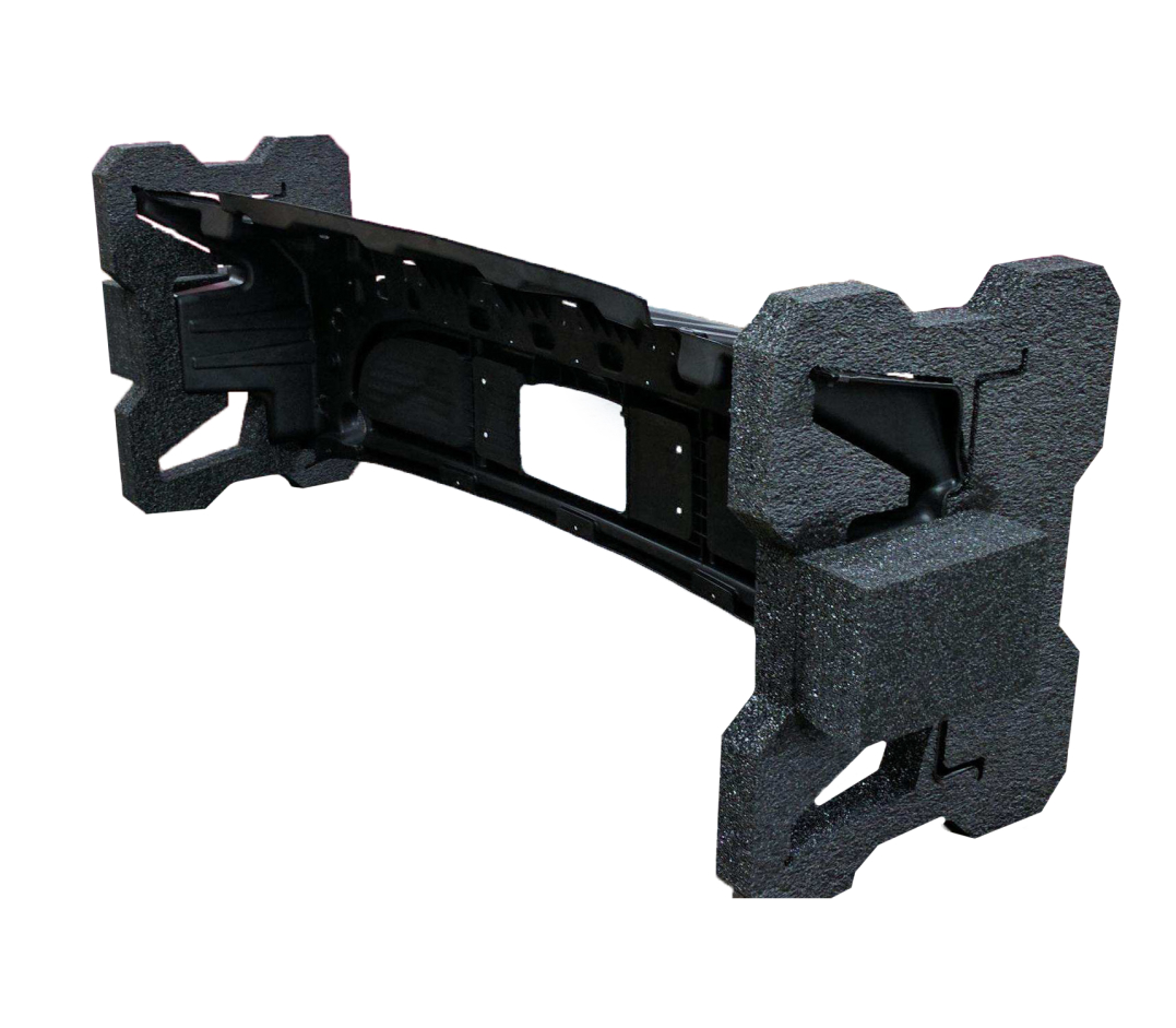 Black car bumper reinforcement with attached foam impact absorbers on each end.