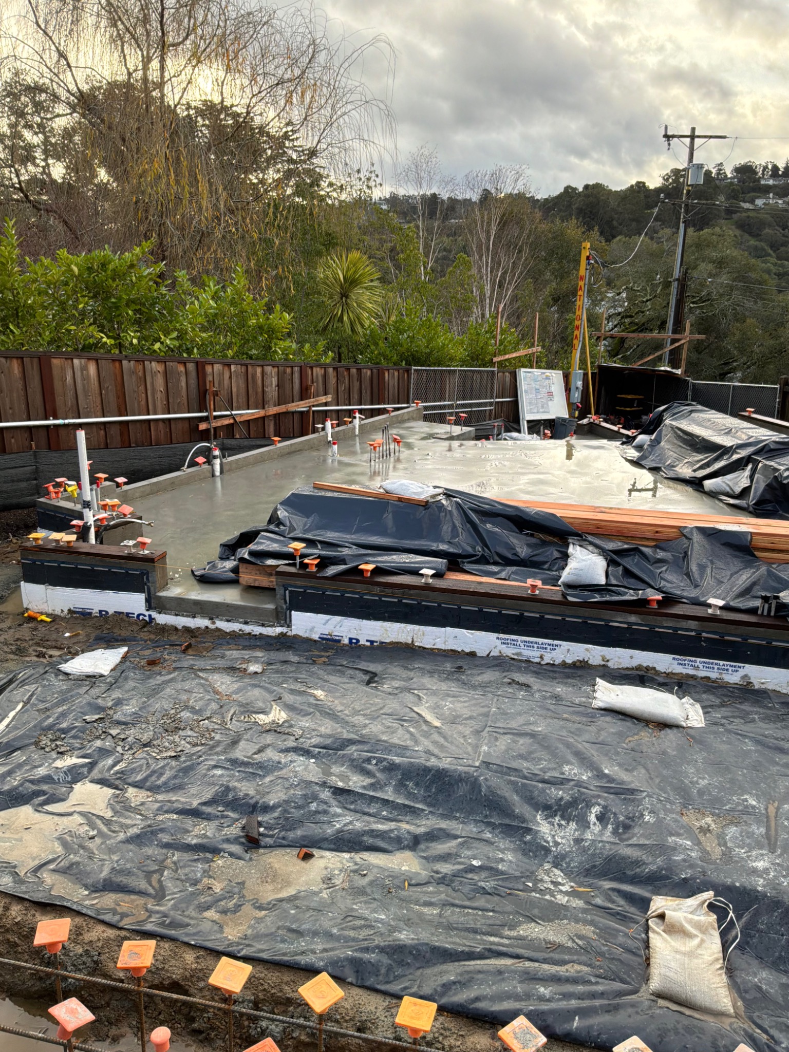 Foundation preparation with reinforcing steel and vapor barrier.