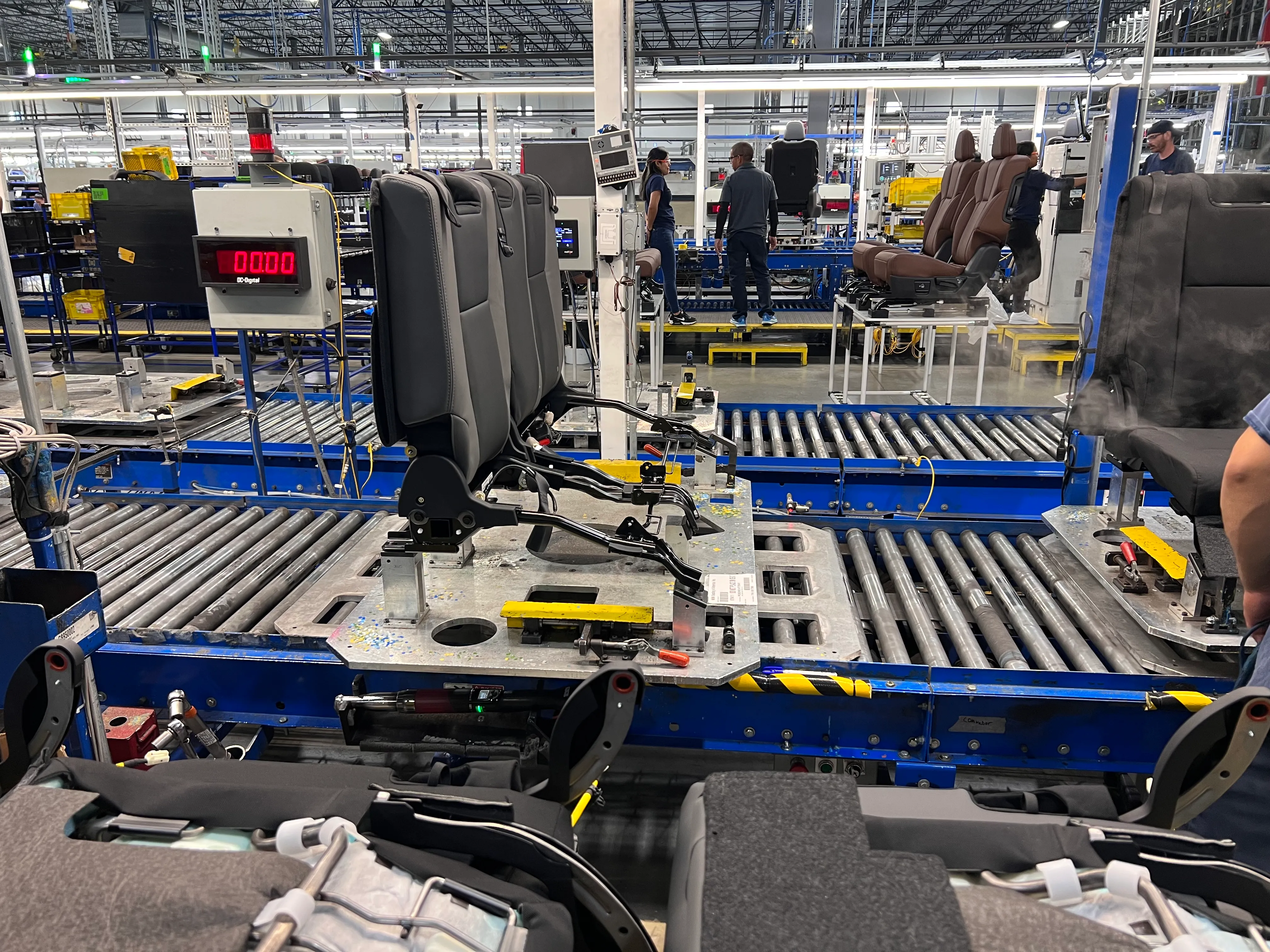 Automotive seat frames being assembled on a custom conveyor tooling line