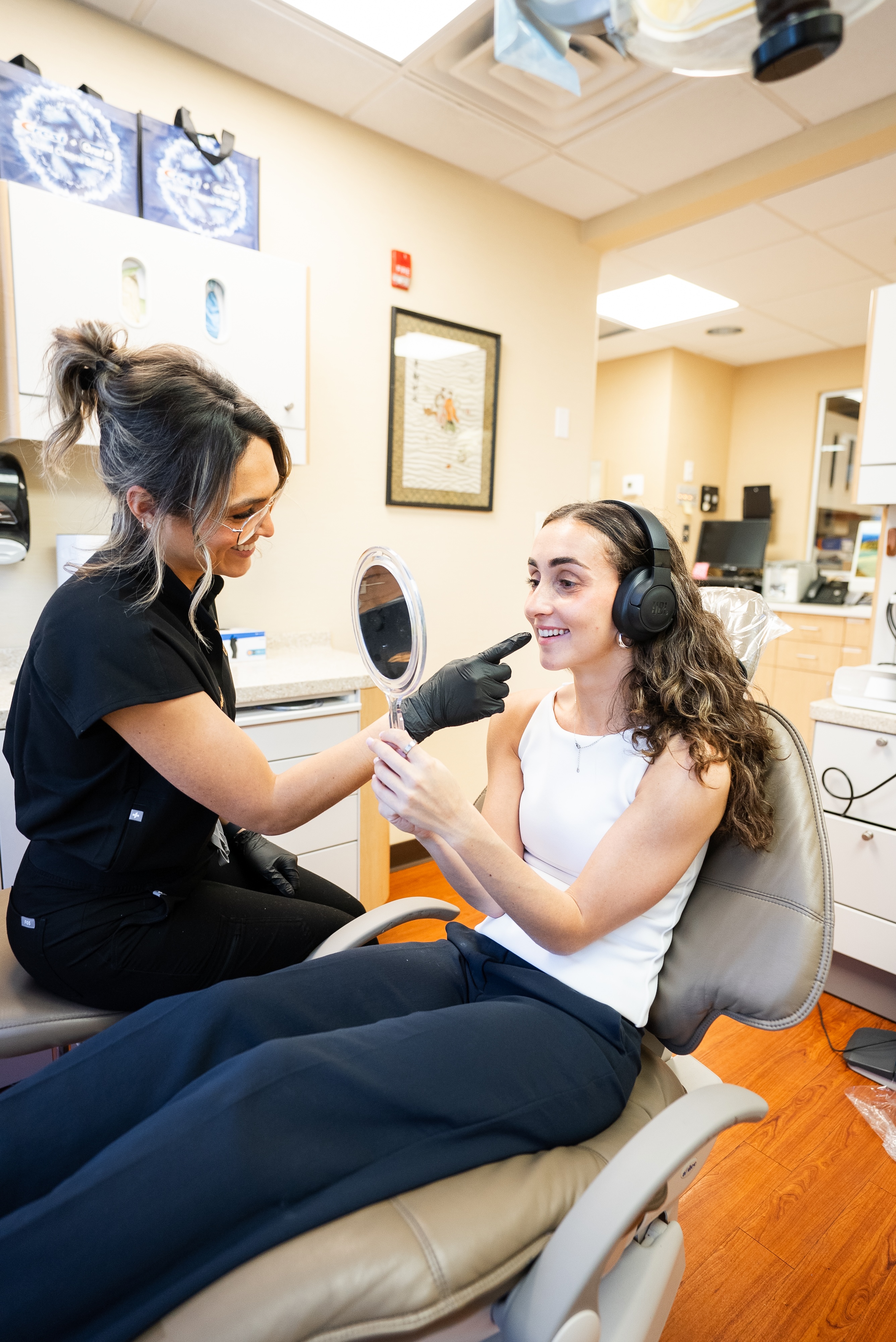 a patient meeting with the dental hygienist for their cleaning at Davis Dental Aesthetics