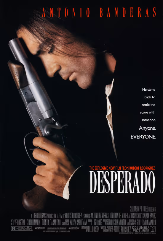 Antonio Banderas holding a shotgun close to his face with eyes closed in a Desperado movie poster.