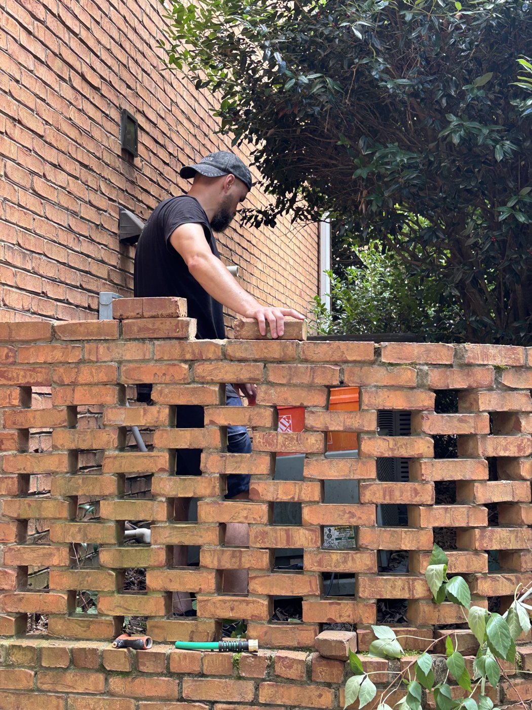 Resetting loose bricks in the courtyard wall