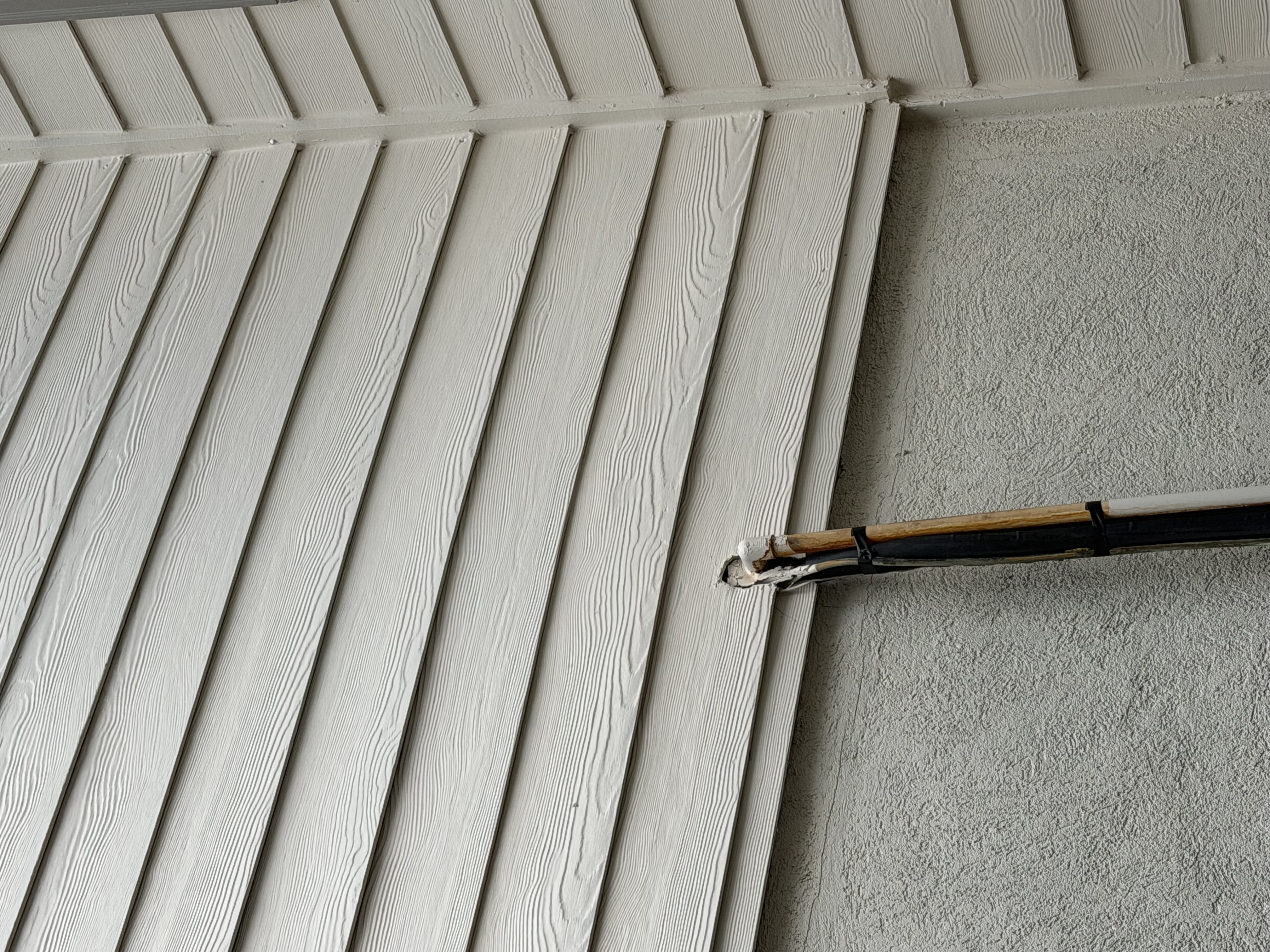 Close up of the AC line entering the wall