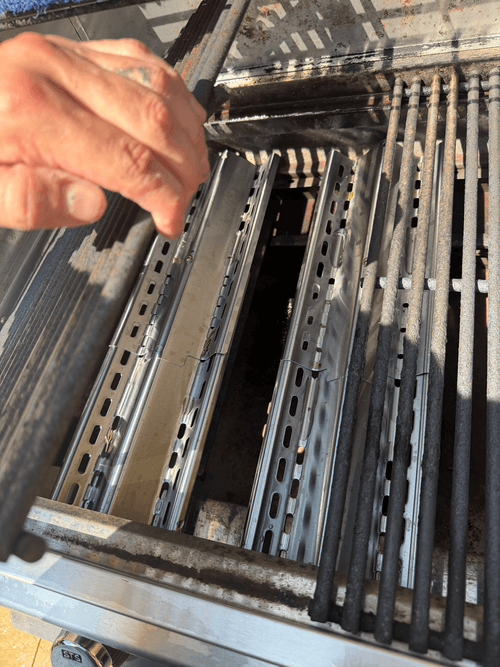 New stainless steel fire slats set over the burners in the built-in grill