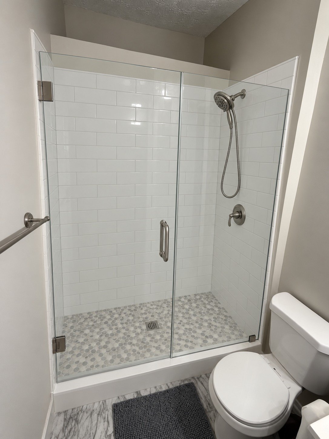 Rendering of the finished shower with subway tile and a glass enclosure