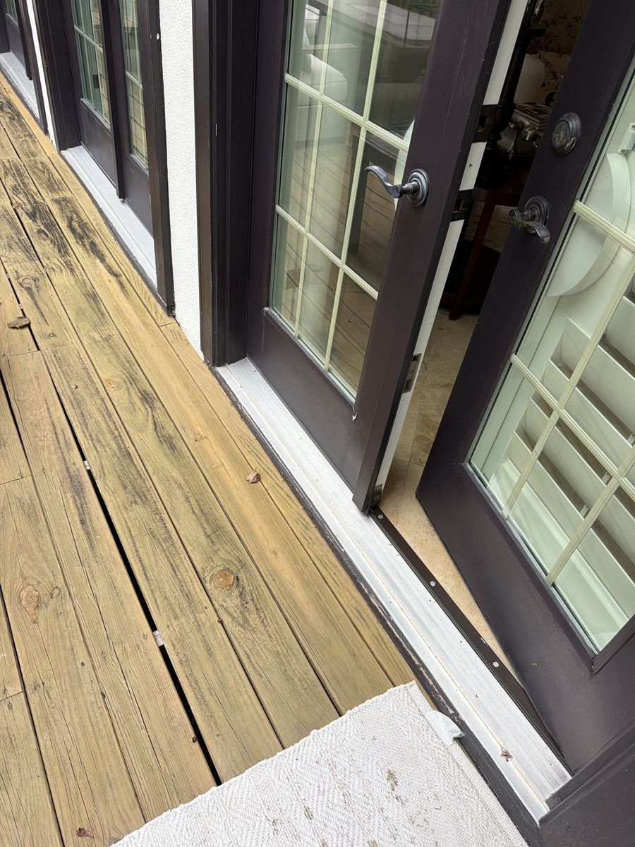 Worn door sill at deck