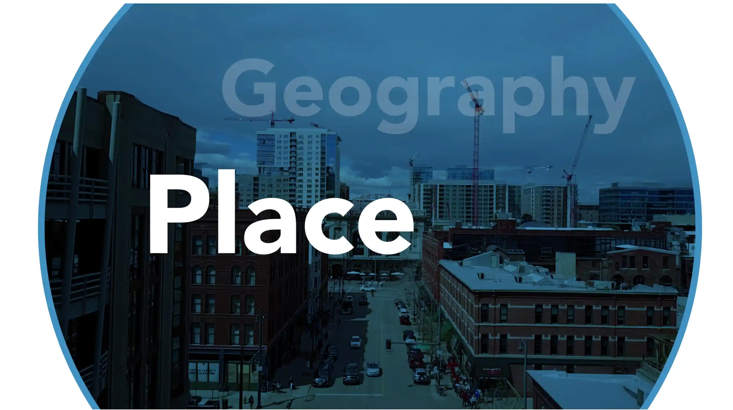 City street with buildings and cranes under a cloudy sky, with "Geography Place" text overlay.