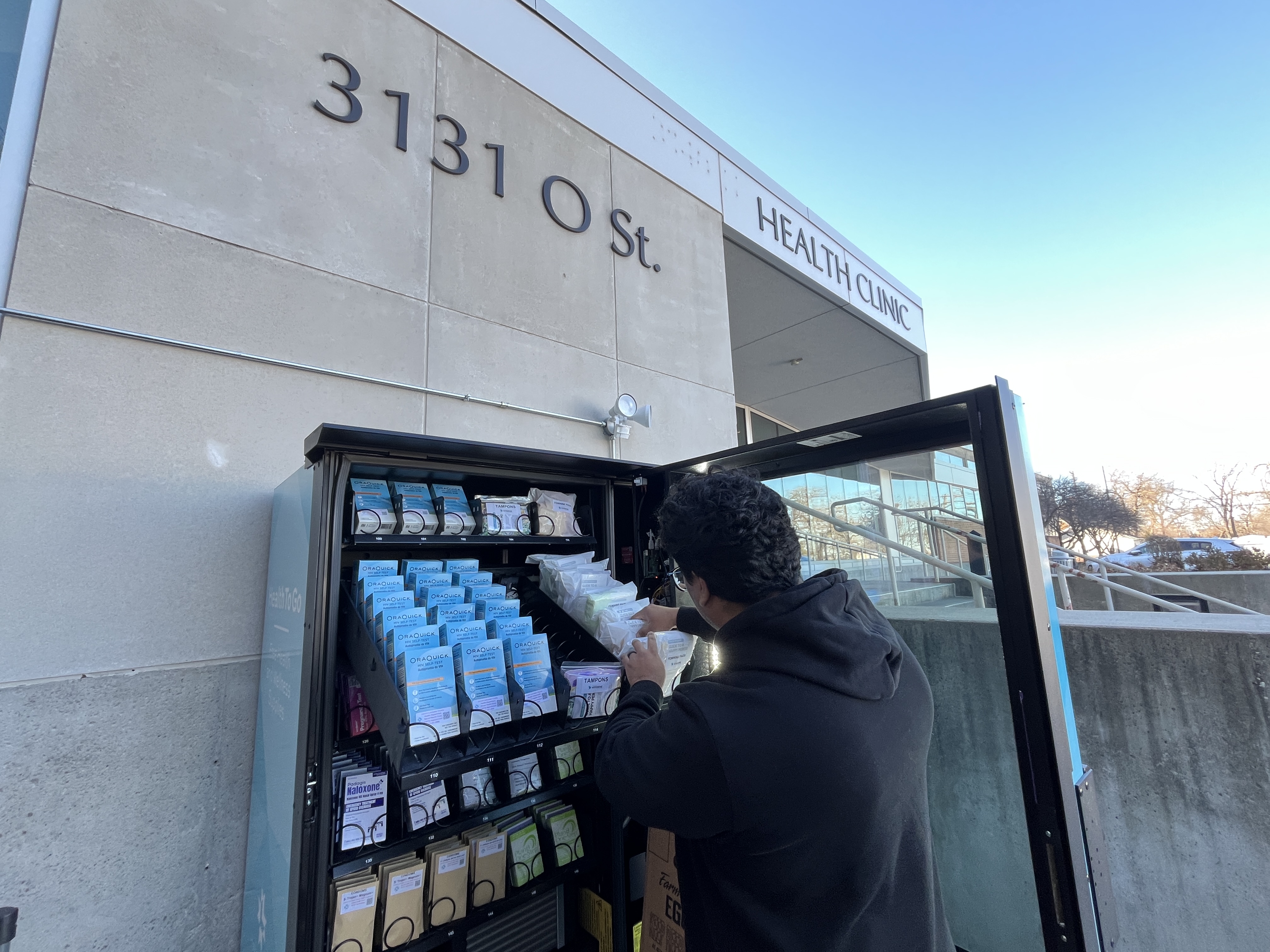 Colorful health resources vending machine with Douglas County Health Department logo, testandgo display, and specimen return slot.