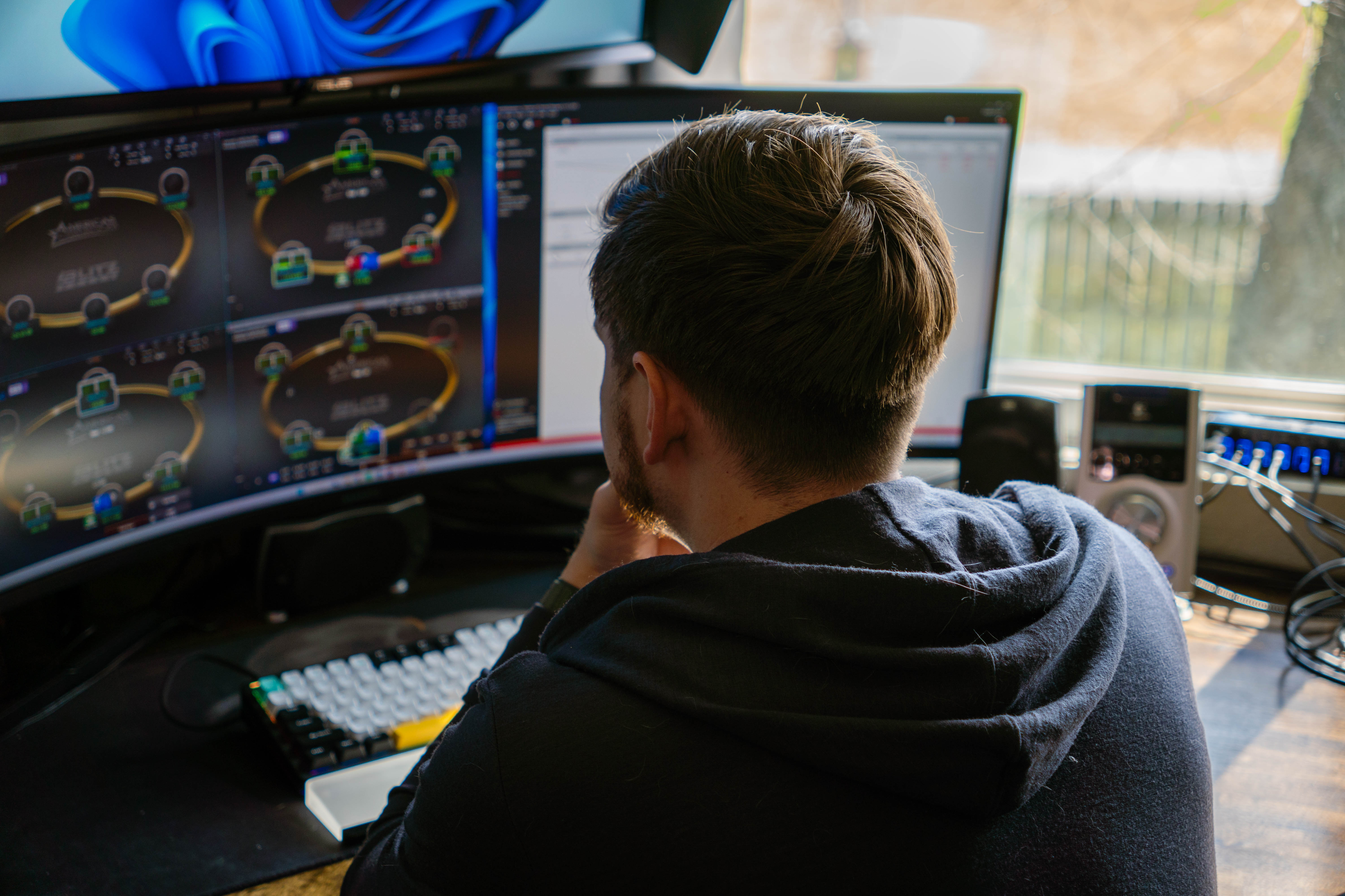 Jared Alderman reviewing hands at his desk