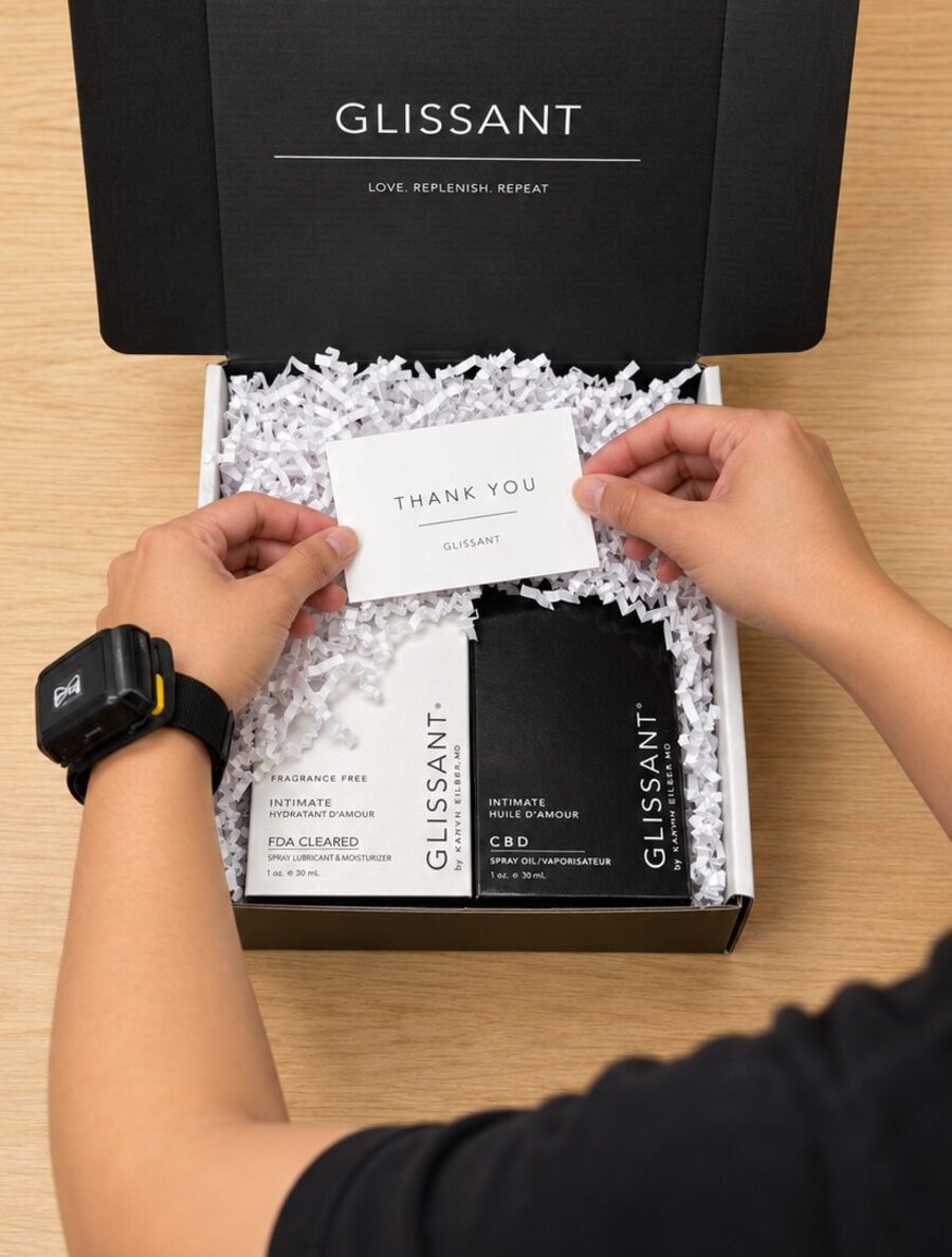 Packer placing a thank-you card into a Glissant subscription box at Stride Logistics' Los Angeles fulfillment center