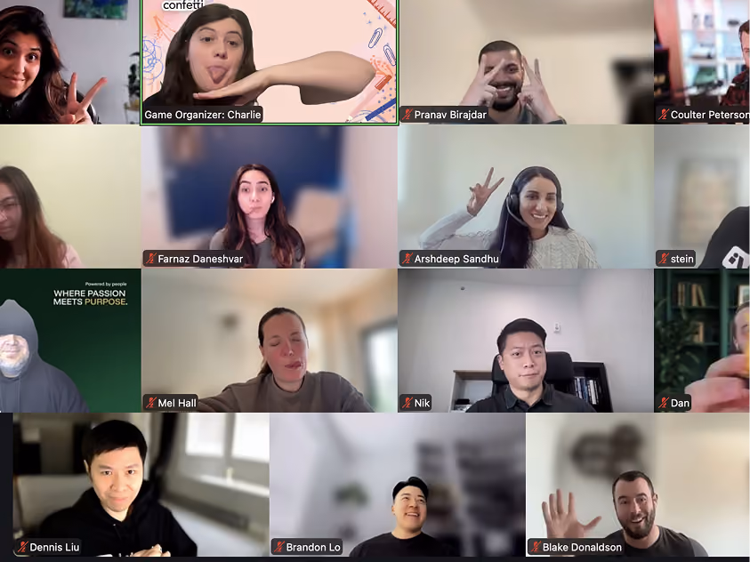 Grid of people on a video call, many smiling and showing peace signs, with muted microphones.