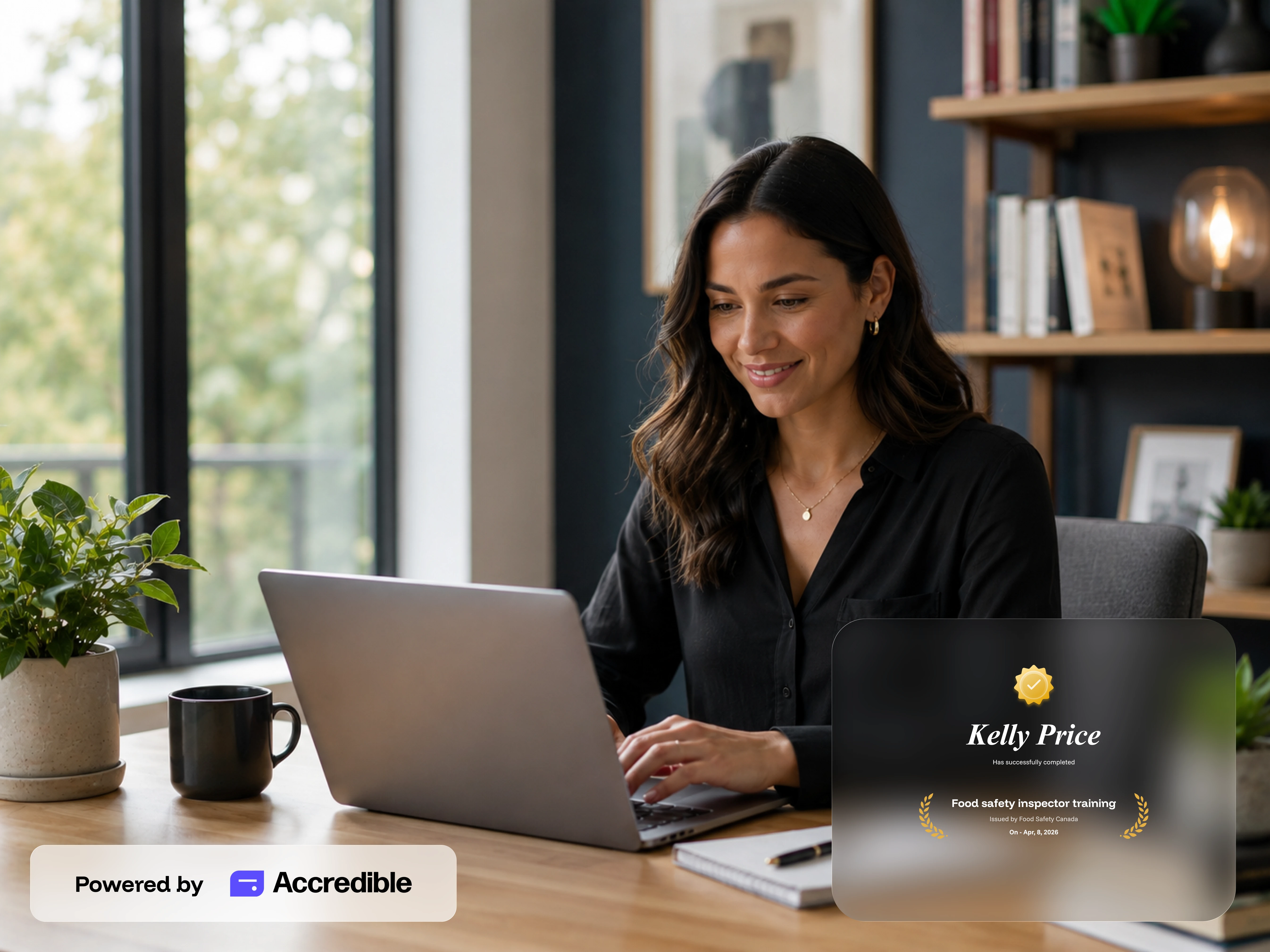 Smiling woman using laptop at desk with plant and certificate for food safety training on screen.