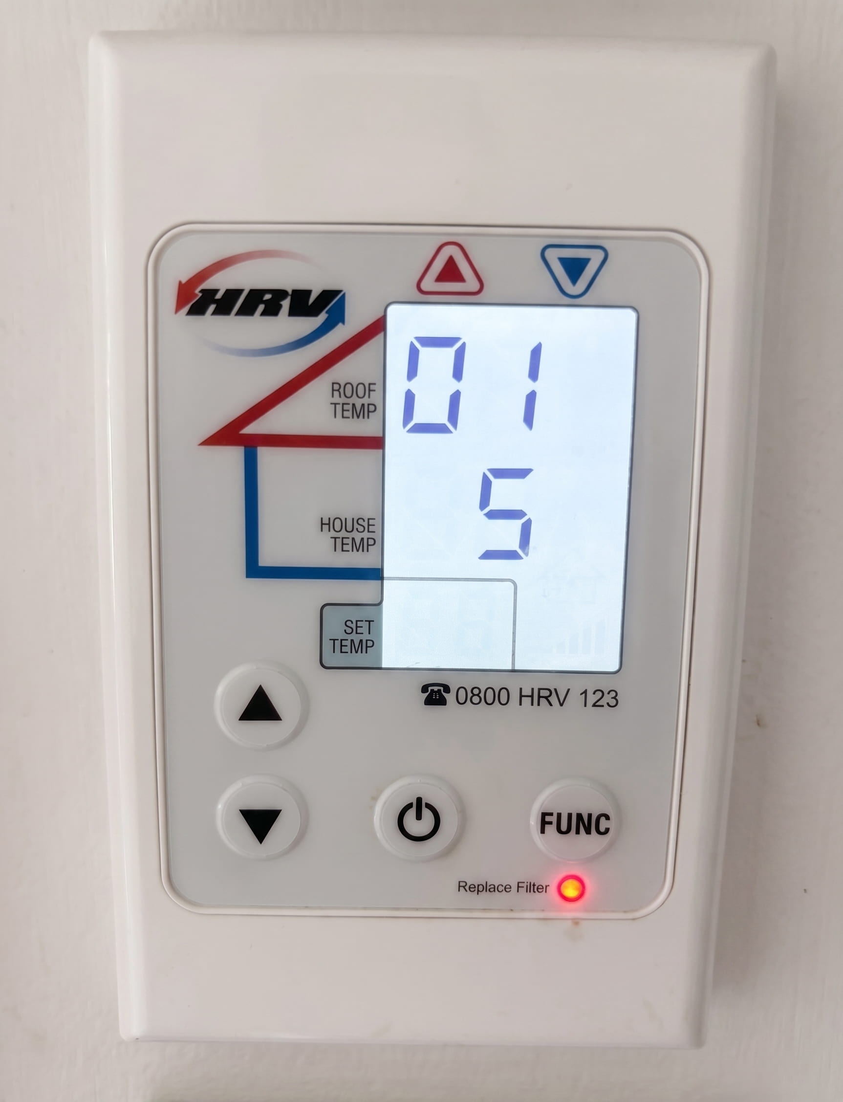 HRV wall controller with the Replace Filter indicator light illuminated, indicating the system filter is due for replacement