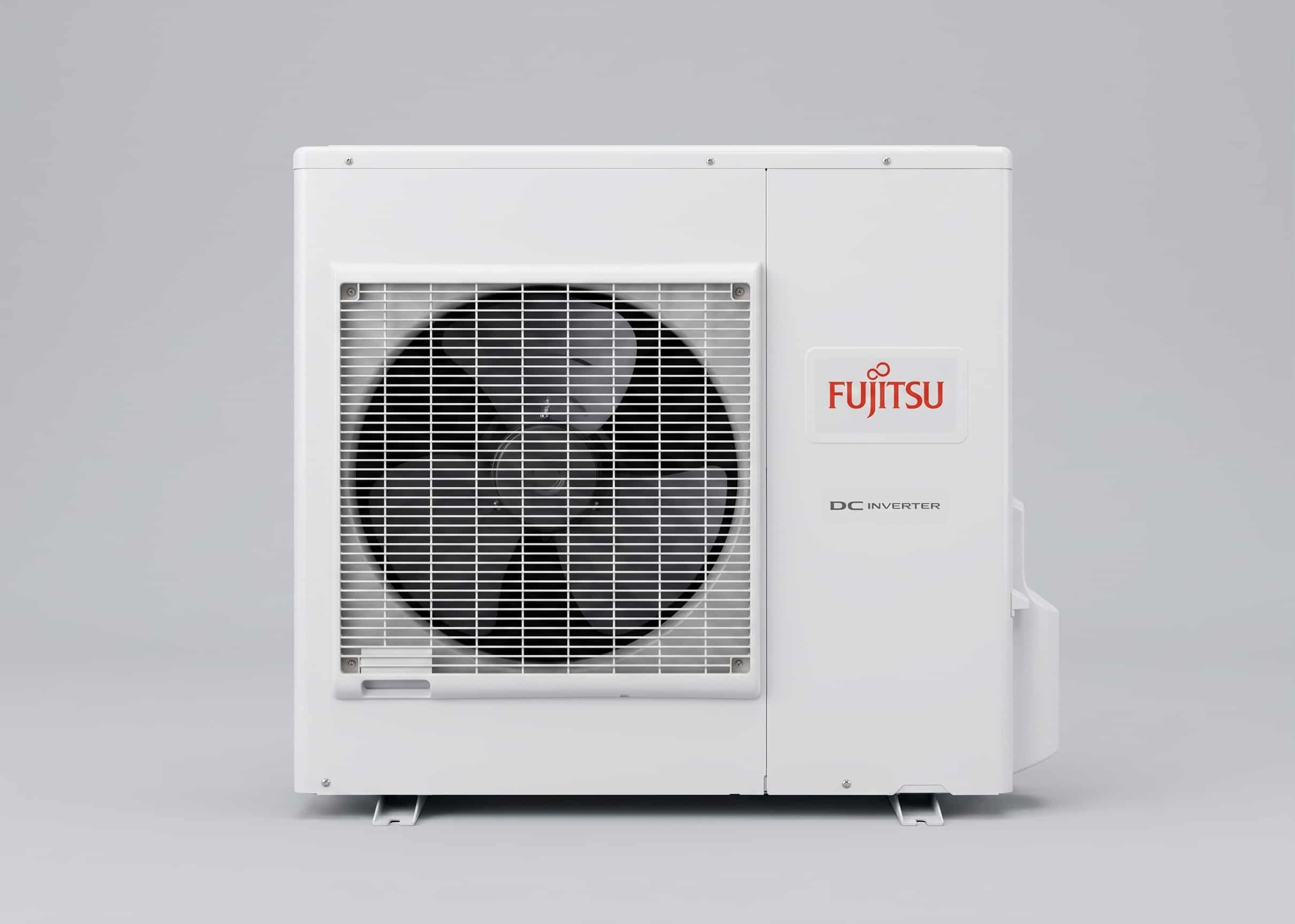 Fujitsu DC Inverter outdoor heat pump unit mounted on wall brackets, showing the external fan grille and white casing